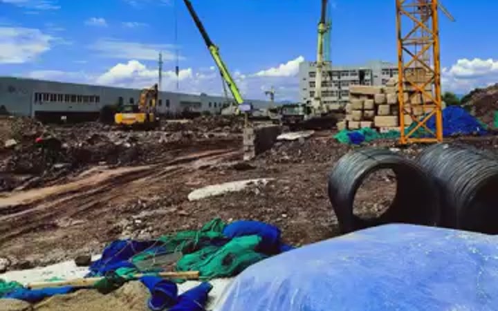 Building site of the new factory with a crane, one year before completion