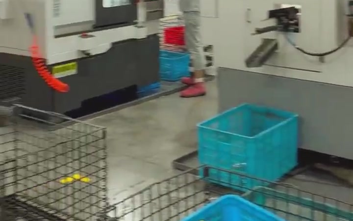 Gitterkörbe und Kisten mit Drehteilen an einer CNC-Maschine